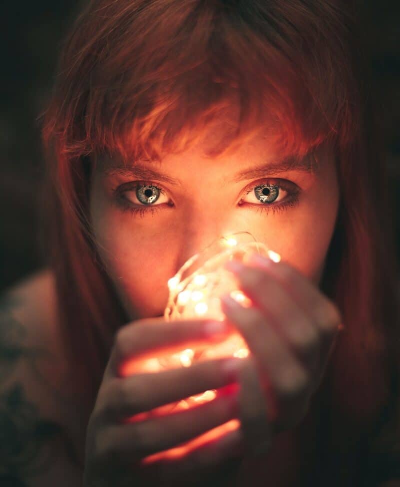 Close-up Photography of Woman Holding String Lights