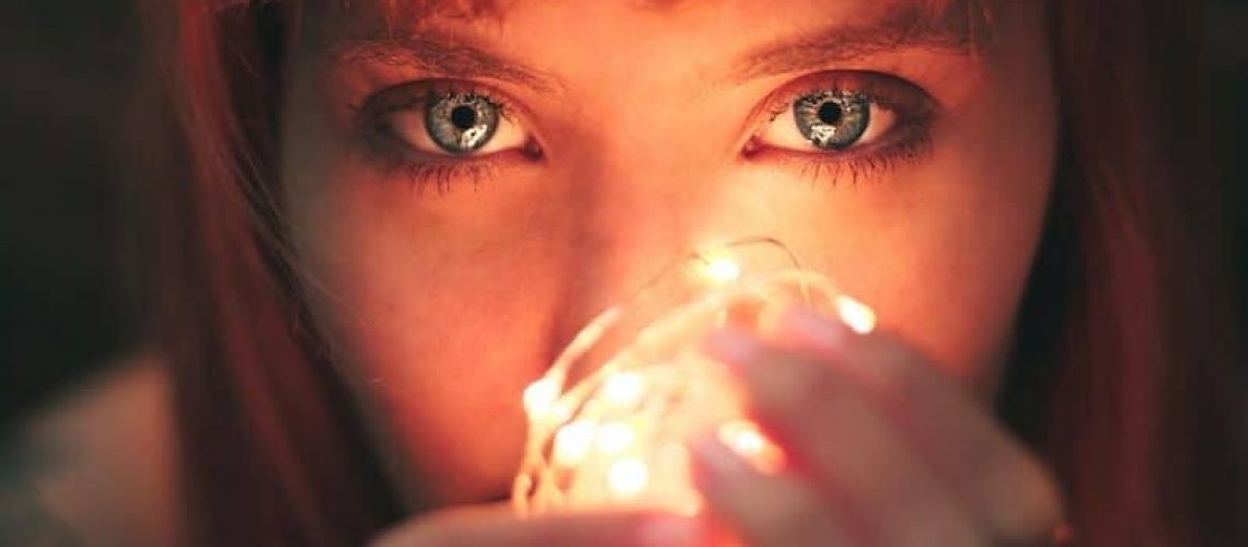 Close-up Photography of Woman Holding String Lights